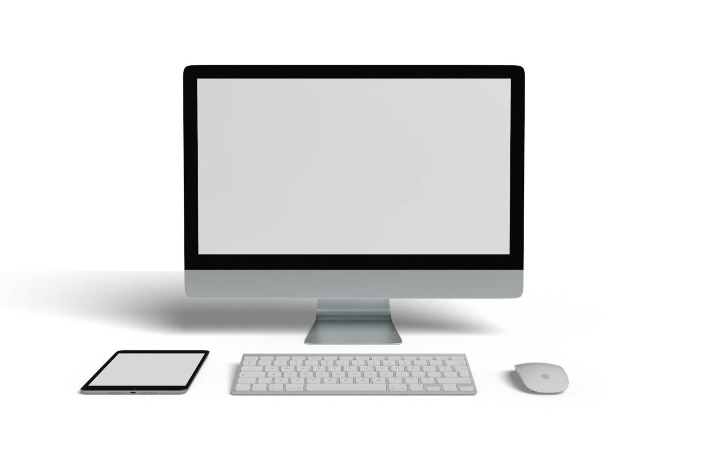 Moderní stolní počítač s monitorem, klávesnicí, myší a tabletem na bílém stole.